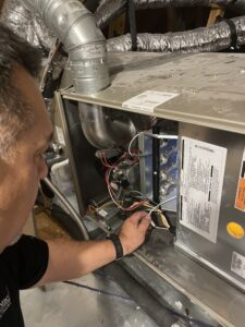 Technician inspecting an HVAC unit